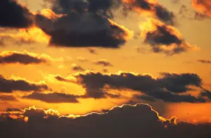 Clouds are pictured at sunset over a beachfront along the Atlantic Ocean coast in