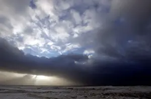 Weather Prints: Clouds are pictured as waves break along Frances Atlantic coastline at sunset in Lacanau