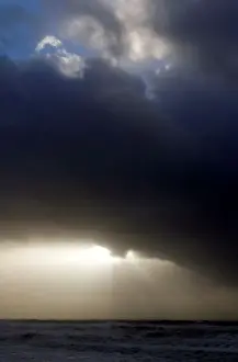 Weather Prints: Clouds are pictured as waves break along Frances Atlantic coastline at sunset in Lacanau