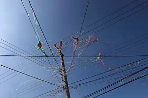 Color ribbon are seen on overhead power lines after firecrackers were set off during