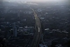 Commuter trains are seen at dawn on the approach to London Bridge rail station in
