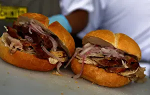A cook prepares sandwich with grilled pork during Mistura gastronomic fair in Lima