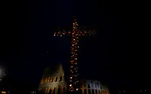 Religion Prints: A cross lit up with candles is seen in front of the Colosseum before the Via Crucis