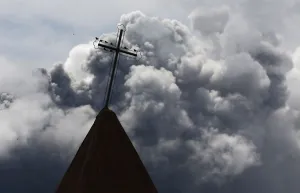 Indonesia Prints: A cross is seen atop a church steeple as ash from Mount Sinabung spews in the background