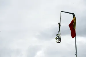 Spain Prints: A crown hangs from a gallows beside a Spanish flag during the Jaque al Rey