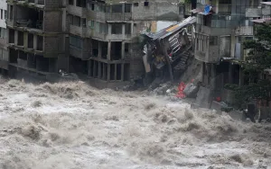 Peru Prints: Damaged buildings, including hotels, are flooded by the Vilcanota river in Machu Picchu