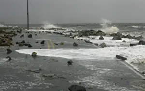 Storm Prints: Debris covers Alligator Drive after Tropical Storm Debby washed out a section of the road