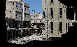 Mideast Prints: Debris from damaged buildings are seen from a hole at a rebel-held area in Deraa