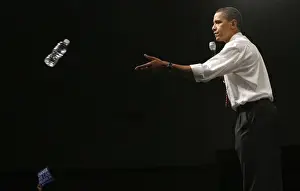 Democratic presidential candidate Senator Barack Obama throws a bottle of water to