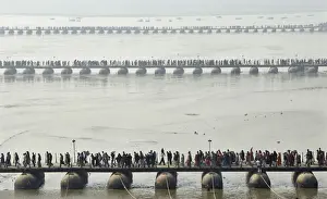 Devotees make their way across pontoon bridges spanning the Sangam during Magh Mela