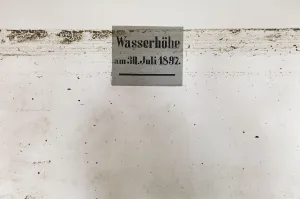 Prints of Dirt marks from a recent flood run across a sign showing the height of a 1897 flood in the Marienthal monastery in the town of Ostritz at the Polish border, August 9, 2010 Germany Prints: Dirt marks from recent flood run across sign showing height of 1897 flood in