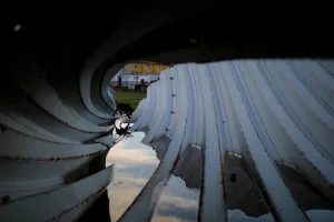 A dog passes by pieces of metal roof in an area affected by Hurricane Maria A dog passes by pieces of metal roof in an area affected by Hurricane Maria