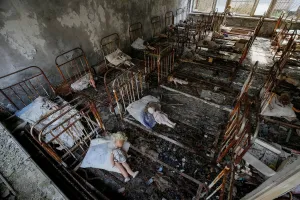 Ukraine Prints: Dolls, which were placed by a visitor, lie at beds at a kindergarten in the abandoned