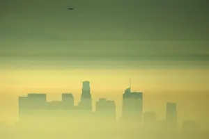 Dailylife Prints: Downtown Los Angeles and an airplane are seen through the morning marine layer in Los