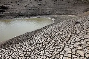 Honduras Prints: Dried mud is seen during a low-level period of water in Concepcion reservoir on