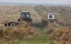 Prints of Drivers operate tractors to gather hay for a small private farm, outside the Siberian village of Bazandaikha in the Republic of Khakassia, Russia, July 23, 2019. Picture taken July 23, 2019 Russia Prints: Drivers operate tractors to gather hay in the Republic of Khakassia
