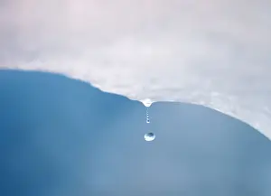 A drop of water falls from a melting piece of ice on Argentinas Perito Moreno glacier