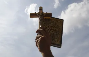 Egypt Prints: An Egyptian holds up a Koran and a cross during a rally to demonstrate the unity between