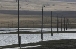 Prints of Electricity pylons are seen on the flooded banks of a lake in the Siberian village of Intikul, in Krasnoyarsk region, Russia April 22, 2018. Pictures taken April 22, 2018. REUTERS/Ilya Naymushin Russia Prints: Electricity pylons are seen on the flooded banks of a lake in the Siberian village of