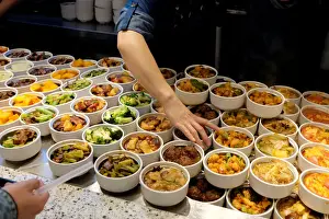 An employee gets pork balls for a customer at a restaurant in Beijing