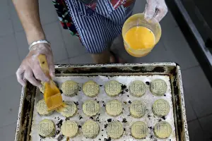 Hongkong Prints: An employee makes mooncakes with anti-extradition bill slogans at Wah Yee Tang Bakery in