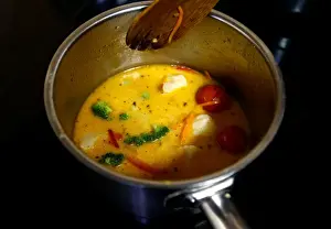 Employee prepares a soup in vegetarian restaurant Green Cuisine in Minsk
