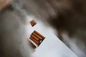 Spain Prints: Esteladas are reflected in a puddle of water three days after the banned independence