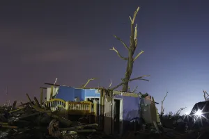 Tornado Prints: The evening light illuminates a childs bed in a destroyed home