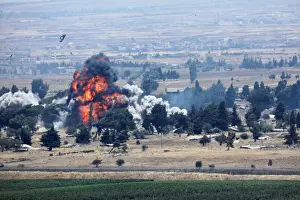 Mideast Prints: An explosion is seen at Quneitra at the Syrian side of the Israeli Syrian border as it is