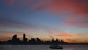 A ferry crosses the river Mersey during sunrise in Liverpool