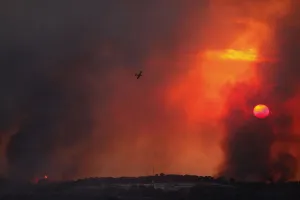 A fire-fighting plane flies over a forest fire that broke out in the north of Israel A fire-fighting plane flies over a forest fire that broke out in the north of Israel