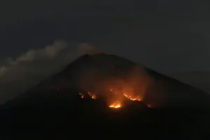 Indonesia Prints: Fire is seen on the slopes of Mount Agung volcano following an eruption as seen from Amed