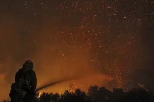 Fire Prints: A firefighter douses embers from the Springs Fire at Point Mugu State Park