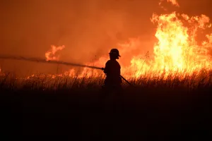 Images Dated 2018 April: A firefighter works to control the Rhea fire near Seiling