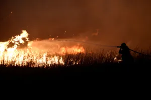 Images Dated 18th April 2018: A firefighter works to control the Rhea fire near Seiling