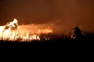 Images Dated 18th April 2018: A firefighter works to control the Rhea fire near Seiling