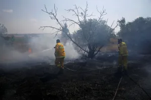 Prints of Firefighters try to extinguish fire on the Israeli side of the border fence between Israel and Gaza, near kibbutz Mefalsim, Israel May 11, 2018. REUTERS/Amir Cohen Israel Prints: Firefighters try to extinguish fire on the Israeli side of the border fence between