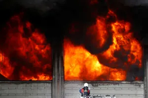 Turkey Prints: A fireman tries to extinguish a fully developed fire at a plastic factory in Istanbul
