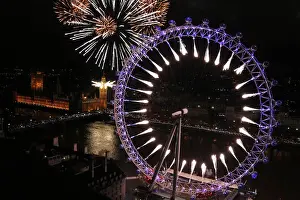 Fireworks explode from The Big Ben clock tower and the London Eye during New Year
