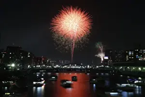 Fireworks explode over high-rise buildings and Tokyos Sumida river during the Sumida