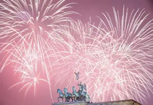 New Year Prints: Fireworks explode next to the Quadriga sculpture atop the Brandenburg gate during New