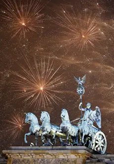 Images Dated 2014 December: Fireworks explode next to the Quadriga sculpture atop the Brandenburg gate during New