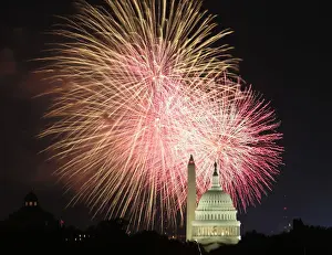 Fireworks explode over the United States Capitol dome and Washington Monument on Independence