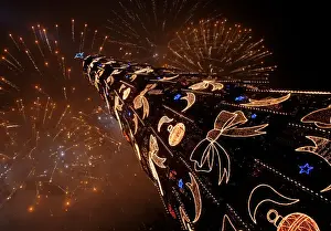 Fireworks light up above one of the highest Christmas trees in Europe in Warsaw