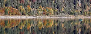 Weather Prints: A fisherman rows his boat during a sunny autumn day at the Sylvenstein barrier lake