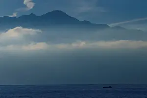 Swiss Prints: A fisherman sails to his net early morning on Lake Leman in Lausanne