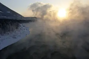 Weather Prints: A fisherman is seen on a bank of the Yenisei River at sunset near the Krasnoyarsk hydro