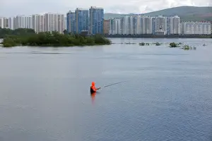 Oddly Prints: A fisherman stands in the waters of the Yenisei River in the Siberian city of Krasnoyarsk