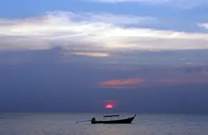 Fishing boat sits anchored in calm waters off coast in Thailands Phang Nga province
