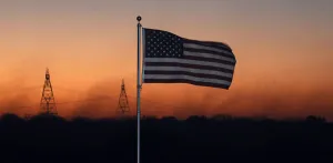 A US flag waves as smoke billows in the Hill Fire in Oak Hills in the Cajon Pass in A US flag waves as smoke billows in the Hill Fire in Oak Hills in the Cajon Pass in